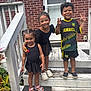 children, kids, porch, steps, brick_wall, door, smiling, black_dress, soccer_jersey, sandals, crocs, outdoor, happy, posing, group, siblings, plants, wooden_stairs, summer, daylight