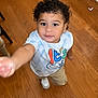 Clarence is registered to the contest to win money with this photo: bodypart, boy, child, clothing, face, finger, hand, hardwood, head, indoors, interiordesign, male, pants, person, photography, plywood, portrait, t_shirt, text, wood