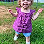 child, curly_hair, cute, daylight, denim_shorts, fence, grass, happy, lawn, nature, outdoor, person, playful, purple_clothing, smiling, sunny, toddler, walking, white_shoes, young_child