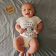 Ezra joined the competition — help win amazing prizes! baby, infant, smiling, onesie, park_ranger, wooden_sign, five_months, lying_down, blanket, cute, happy, child, human, skin, head, arms, legs, feet, indoors, portrait