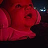 Ezra joined the competition — help win amazing prizes! baby, headphones, red_light, night, dark_background, face, expression, child, person, portrait, phone_screen, social_media, technology, indoors, closeup, head, mouth_open, looking_up, infant, candid