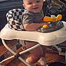 baby, walker, indoor, smiling, child, floor, toy, footwear, sock, clothing, person, furniture, seat, play, happy, head, face, leg, wood_floor, home