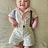 Ezra joined the competition — help win amazing prizes! baby, infant, smiling, suspenders, shorts, shirt, lying_down, happy, cute, child, skin, face, hands, feet, indoor, portrait, one_person, light, soft_texture, clothing