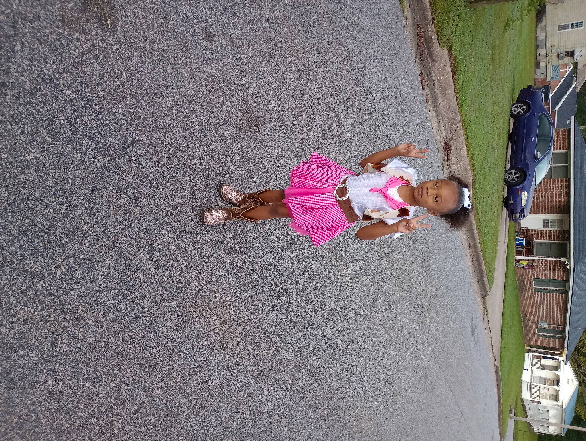 Shi'Laia is registered to the contest to win money with this photo: asphalt, car, child, concrete, fun, house, leisure, pedestrian, person, plant, recreation, road_surface, sidewalk, tire, toddler, tree, vehicle, vehicle_door, wall, window