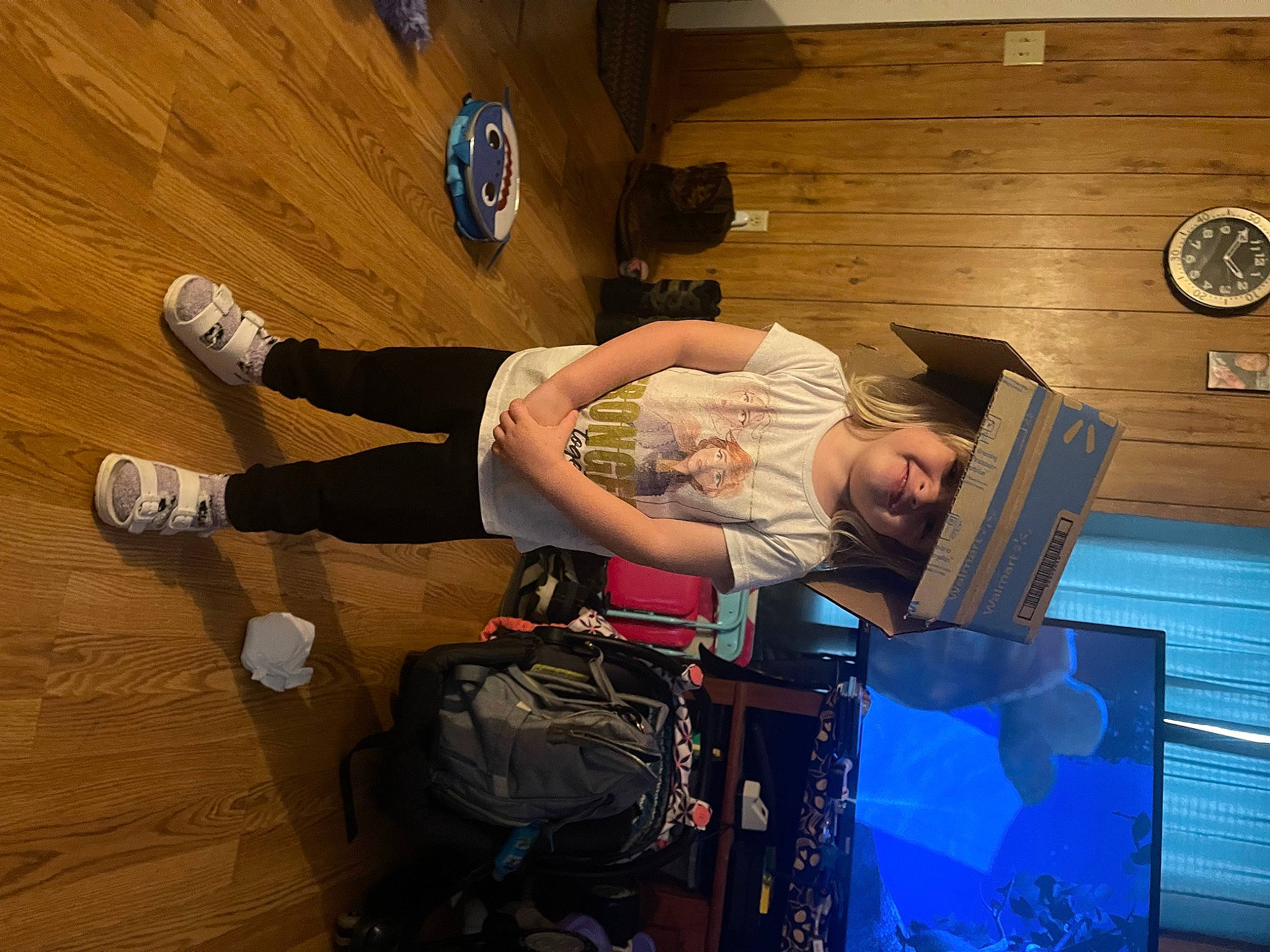 Haylee is registered to the contest to win money with this photo: backpack, bag, baggage, ball, flooring, fun, hardwood, headwear, joy, knee, leisure, luggage_and_bags, motor_vehicle, person, recreation, room, shorts, sitting, sneakers, sports_equipment