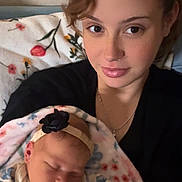 Elisabeth joined the competition — help win amazing prizes! baby, woman, sleeping, blanket, floral, headband, face, skin, portrait, indoor, love, mother, newborn, person, cozy, resting, comfort, clothing, necklace, peaceful