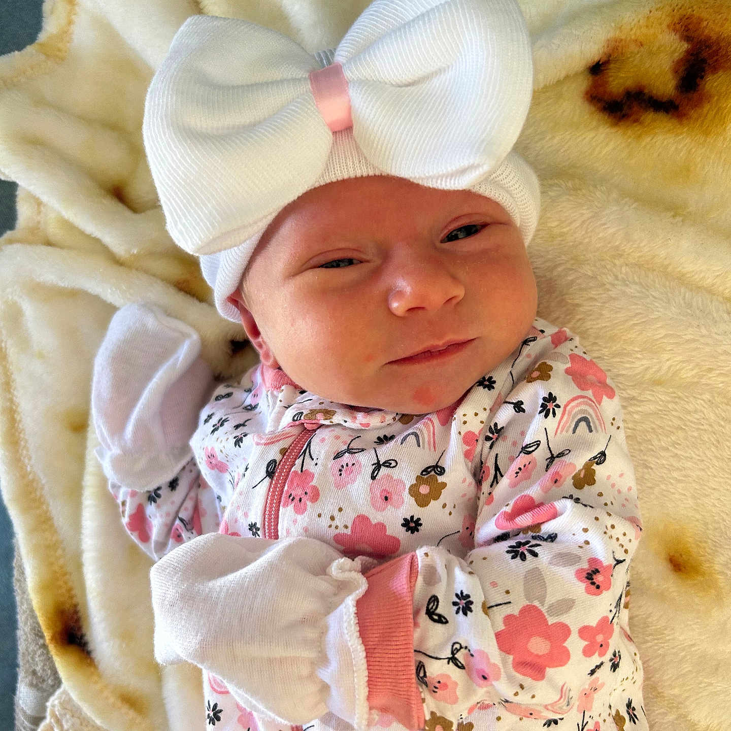 Elisabeth joined the competition — help win amazing prizes! baby, blanket, cute, face, floral, flower_pattern, headwear, indoor, infant, laying, mittens, newborn, onesie, pink, portrait, skin, sleepwear, soft_texture, white, white_bow