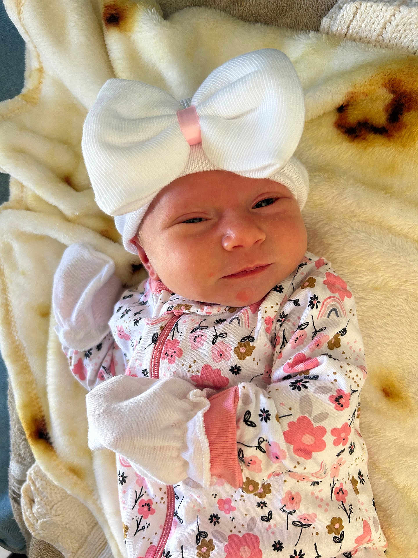 Elisabeth joined the competition — help win amazing prizes! baby, infant, flower_pattern, onesie, white_bow, mittens, blanket, soft_texture, cute, newborn, sleepwear, headwear, pink, white, floral, laying, portrait, indoor, skin, face