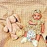 Sophie joined the competition — help win amazing prizes! baby, infant, plush_toy, stuffed_animal, bunny, floral_dress, headband, patterned_blanket, decorative_egg, sitting, indoor, cute, child, two_months, soft_toy, cozy, portrait, smiling, white_socks, young_child
