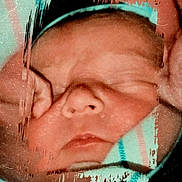 Lonnie joined the competition — help win amazing prizes! newborn, baby, sleeping, face, blanket, striped, headband, closeup, portrait, soft, wrapped, infant, peaceful, child, skin, hands, resting, cozy, warm, indoors