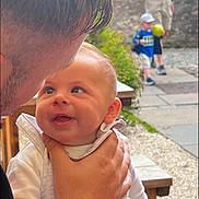 Archie is registered to the contest to win money with this photo: alley, baby, babylaughing, balloon, boy, child, city, clothing, face, footwear, happy, head, hugging, male, newborn, people, person, photography, plant, portrait