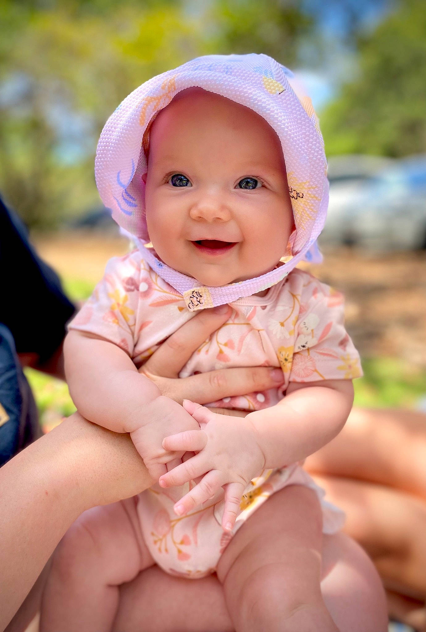 Ivy is registered to the contest to win money with this photo: baby, baby_toddler_clothing, cap, child, face, fashion_accessory, fun, grass, happy, hat, headwear, human_leg, joy, leisure, people_in_nature, person, pink, sitting, skin, smile