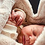 baby, newborn, sleeping, blanket, fur_blanket, cozy, hand, fingers, closed_eyes, face, portrait, infant, swaddle, soft_texture, warmth, sleepwear, lip, eyelashes, bedding, peaceful