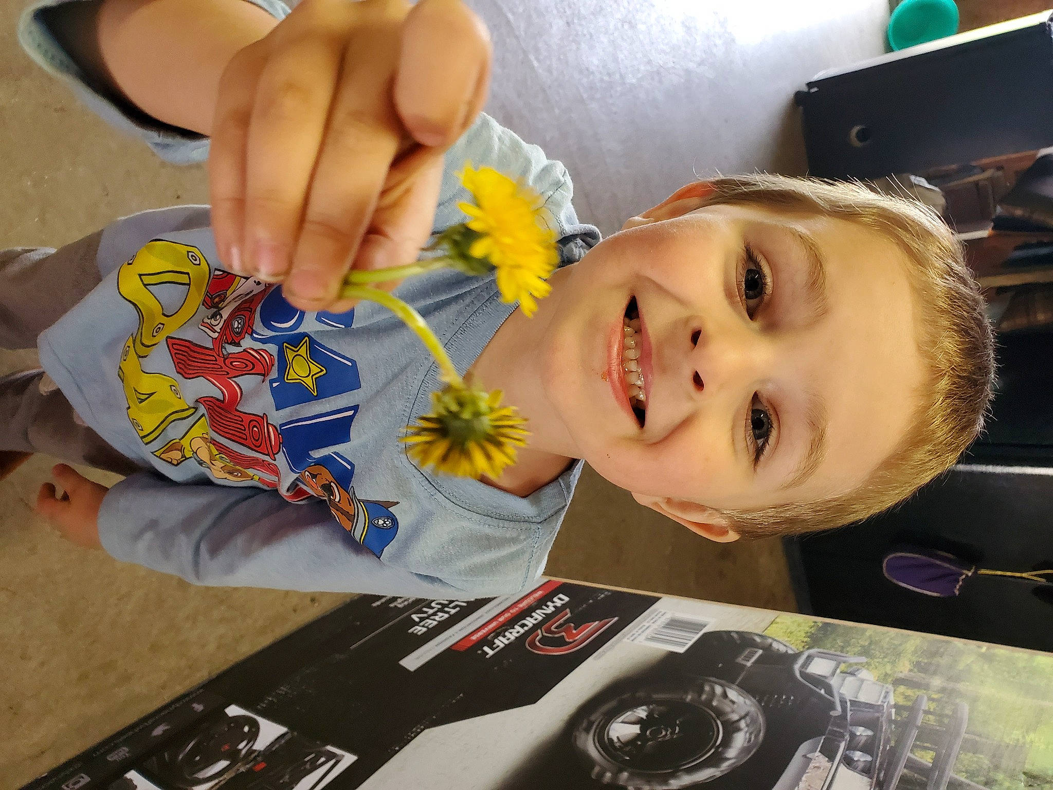 Jonathan joined the competition — help win amazing prizes! chair, child, fashion_accessory, finger, flower, fun, gesture, happy, iris, joy, material_property, nail, person, petal, plant, smile, t_shirt, table, thumb, toddler