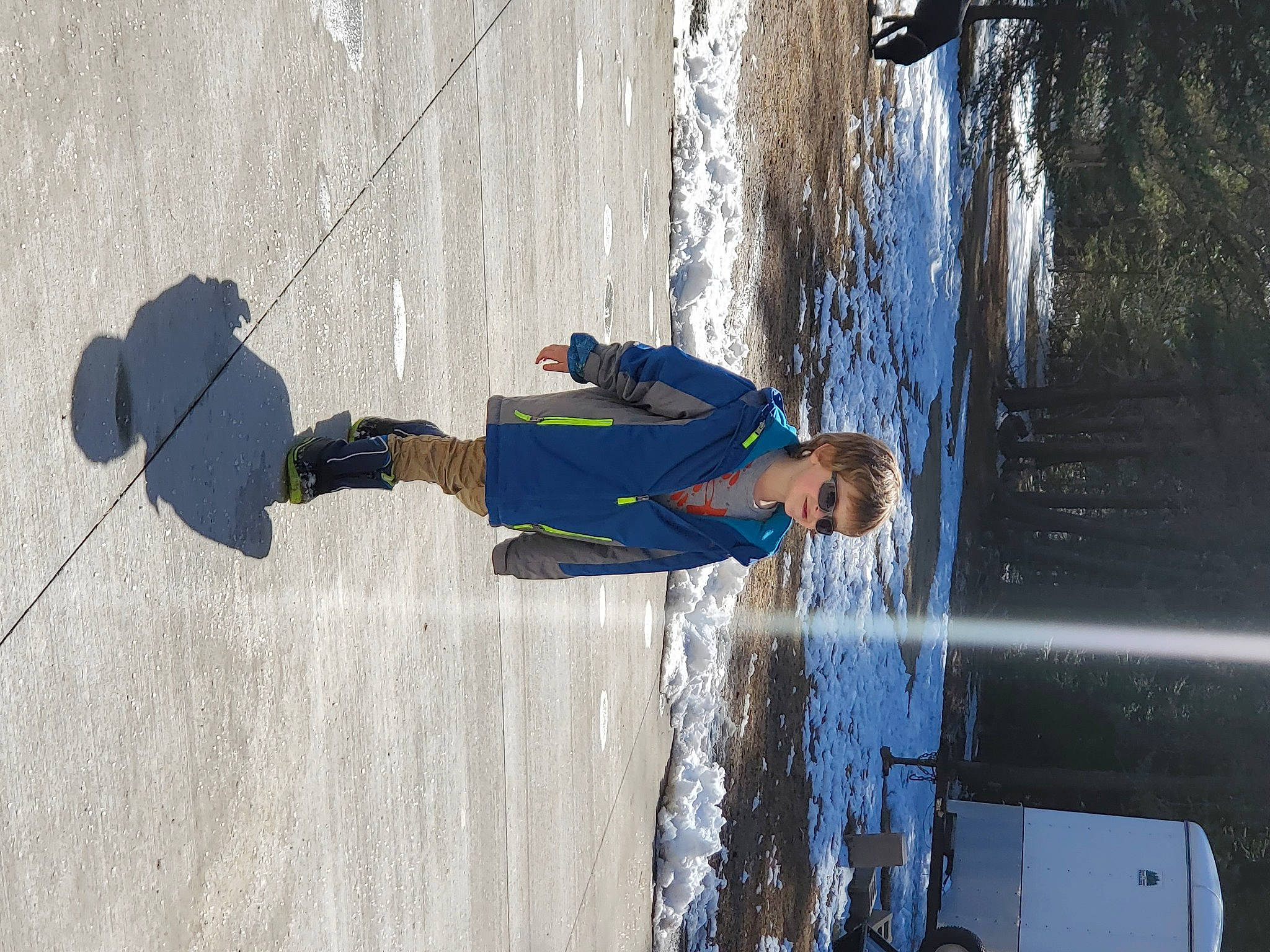 Jonathan is registered to the contest to win money with this photo: boat, boats_and_boating_equipment_and_supplies, electric_blue, freezing, fun, joy, leisure, pedestrian, person, recreation, reflection, shadow, sidewalk, snow, street, street_fashion, tree, water, winter, wood