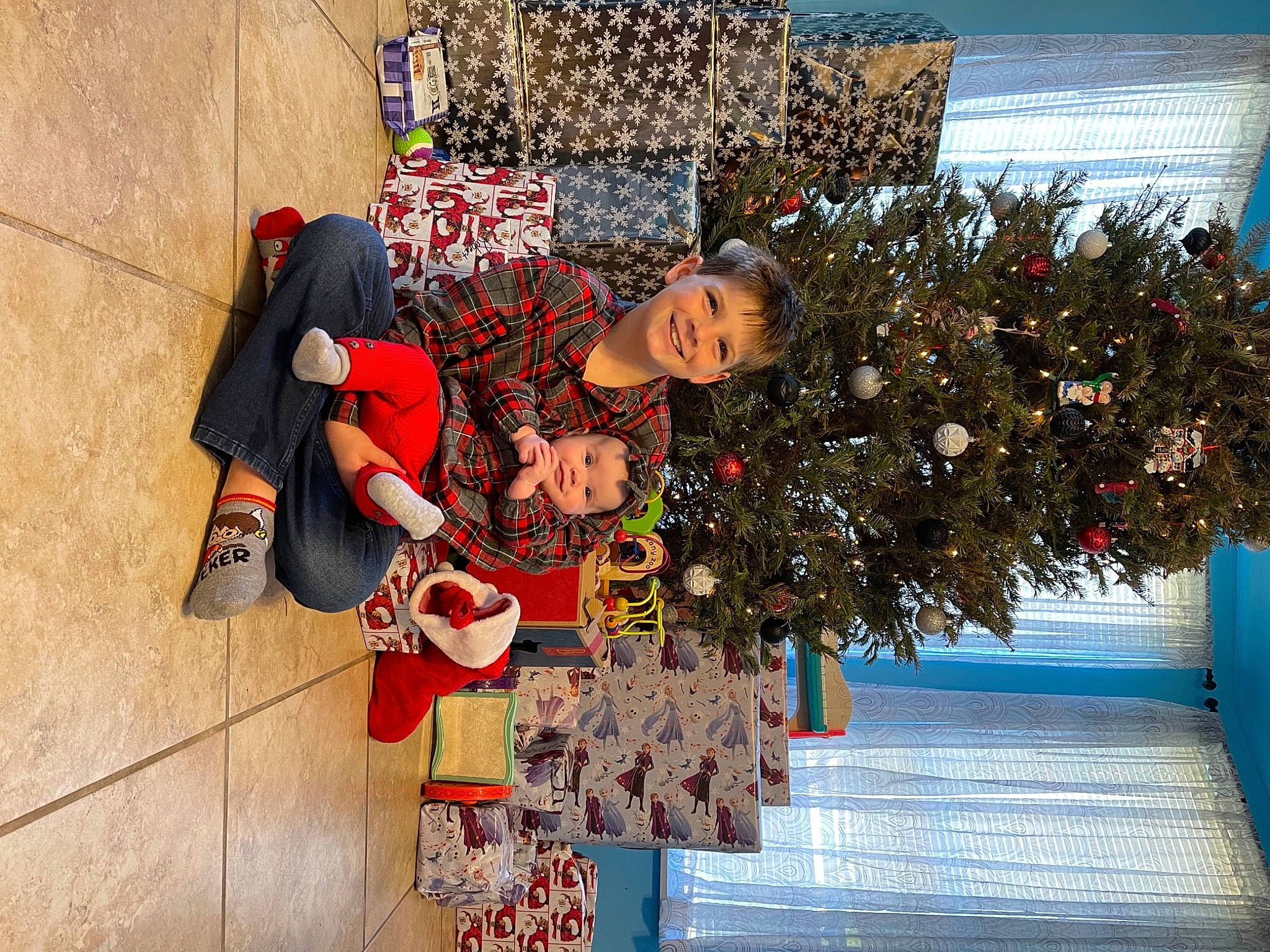 Rylie is registered to the contest to win money with this photo: boot, christmas, christmas_decoration, christmas_eve, christmas_ornament, christmas_tree, conifer, fir, holiday, holiday_ornament, interior_design, joy, ornament, person, pine, pine_family, stuffed_toy, tradition, winter