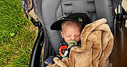 Remmi joined the competition — help win amazing prizes! accessory, baby, blanket, bundle, cap, child, comfort, cute, fabric, grass, infant, nap, outdoor, pacifier, person, relaxation, seat, sleeping, stroller, toy