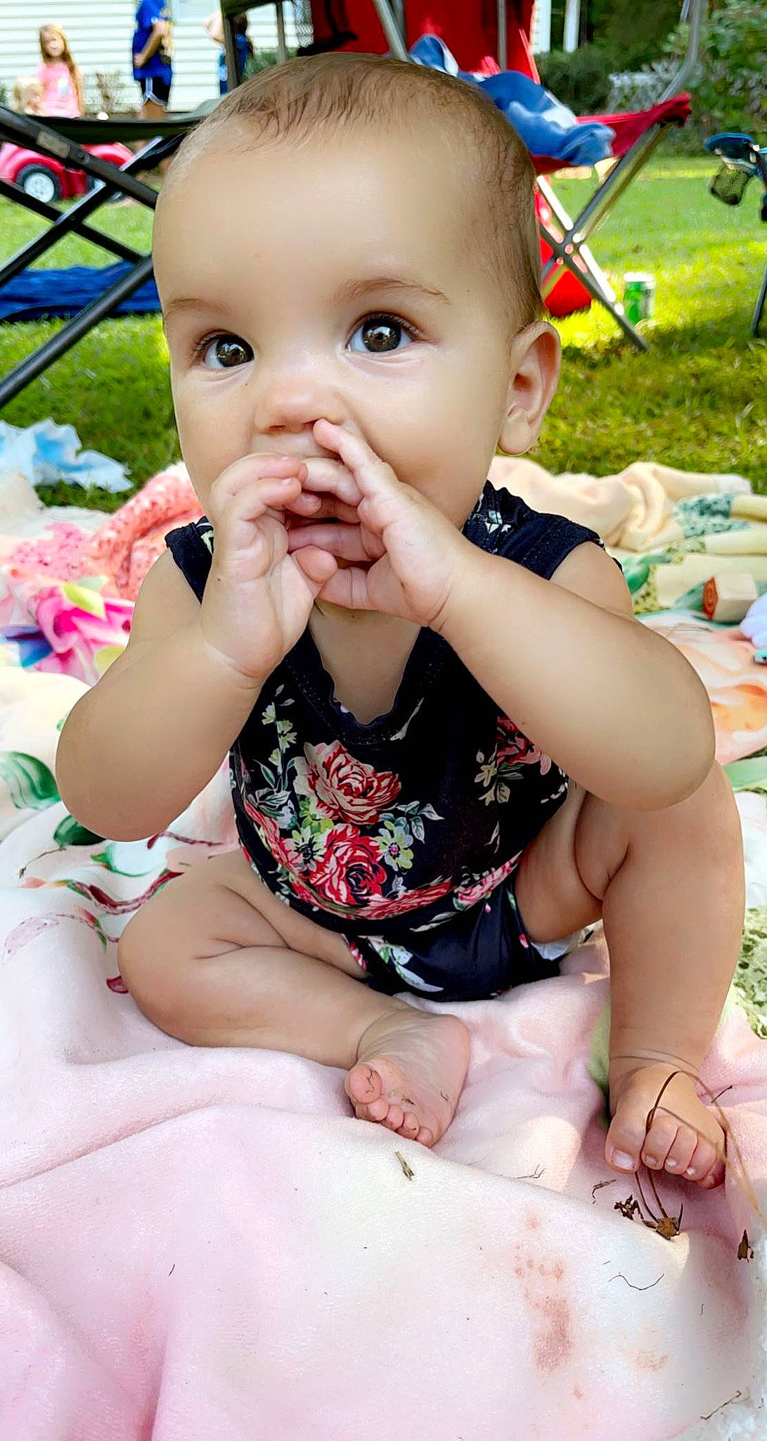 Halston is registered to the contest to win money with this photo: baby, baby_toddler_clothing, chair, cheek, dress, face, finger, grass, green, happy, iris, leg, lip, mouth, nose, person, photograph, pink, skin, toddler