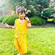 Aakifa joined the competition — help win amazing prizes! child, girl, yellow_dress, traditional_clothing, smiling, outdoor, grass, greenery, nature, playful, happy, sunny, bracelets, barefoot, portrait, young, cute, cheerful, daylight, posing