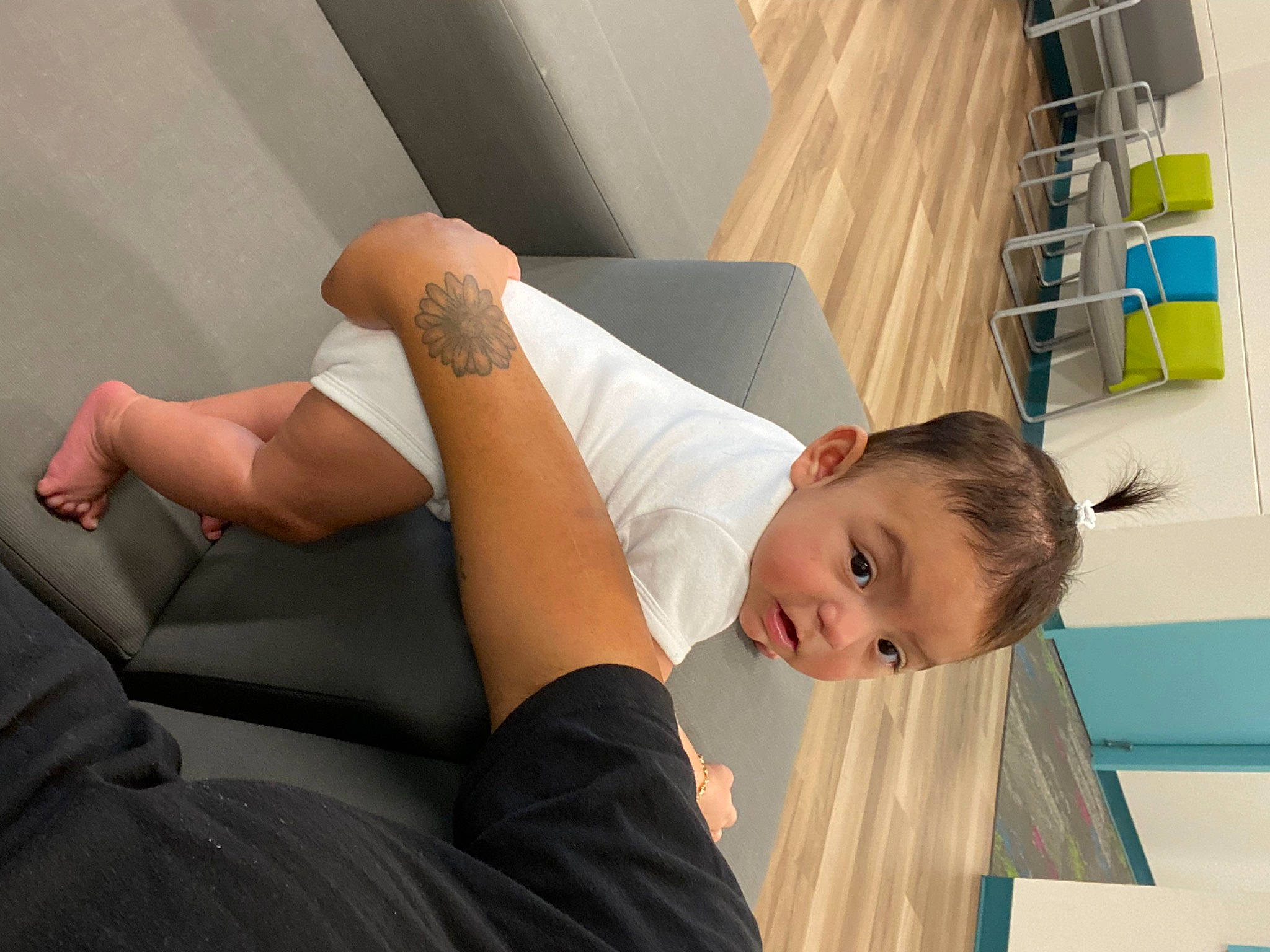 Genesis is registered to the contest to win money with this photo: child, comfort, couch, dress, elbow, floor, flooring, foot, happy, human_body, human_leg, joint, knee, leisure, linens, person, room, shelf, sitting, thigh