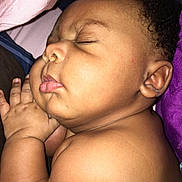 Da'Marko is registered to the contest to win money with this photo: baby, infant, sleeping, peaceful, portrait, close_up, curled_up, hands, face, closed_eyes, curly_hair, brown_skin, blanket, bed, cozy, resting, indoors, photography, adorable, nap