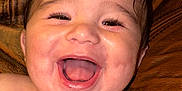Ismaël participe au concours pour gagner de l'argent avec cette photo : baby, background, child, closeup, couch, eyelashes, eyes, face, hair, happy, head, indoors, laughing, leather, mouth, portrait, shoulders, skin, smiling, tongue