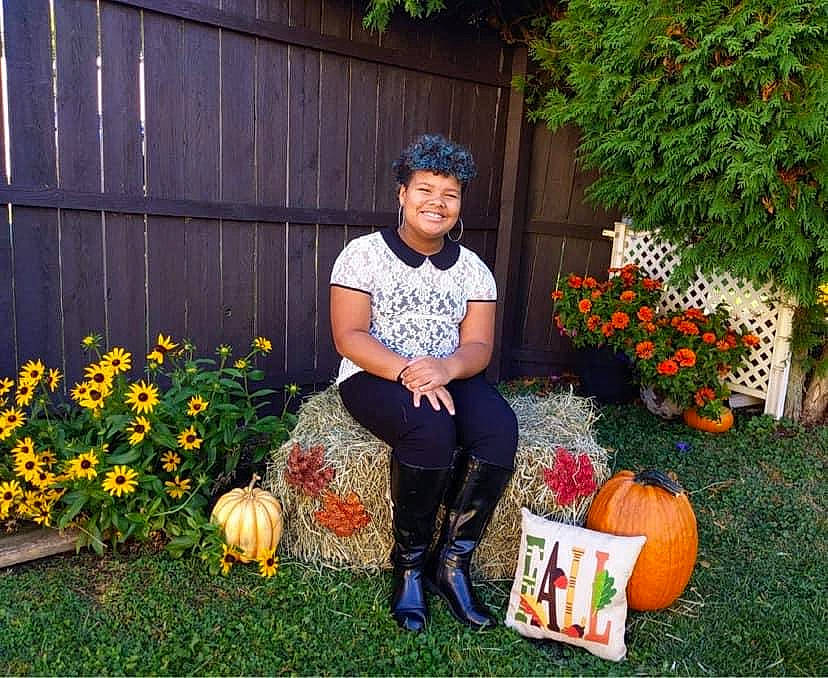 Aiyanna is registered to the contest to win money with this photo: backyard, calabaza, cucurbita, garden, gourd, grass, headwear, joy, lawn, local_food, person, plant, pumpkin, squash, vegetable, winter_squash, yard