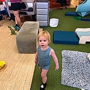 Zachary joined the competition — help win amazing prizes! toddler, child, indoor_playground, carpet, blue_romper, black_socks, adult, furniture, play_area, slide, rug, toy_dinosaur, bench, woman, baby, flooring, people, parenting, childcare, play