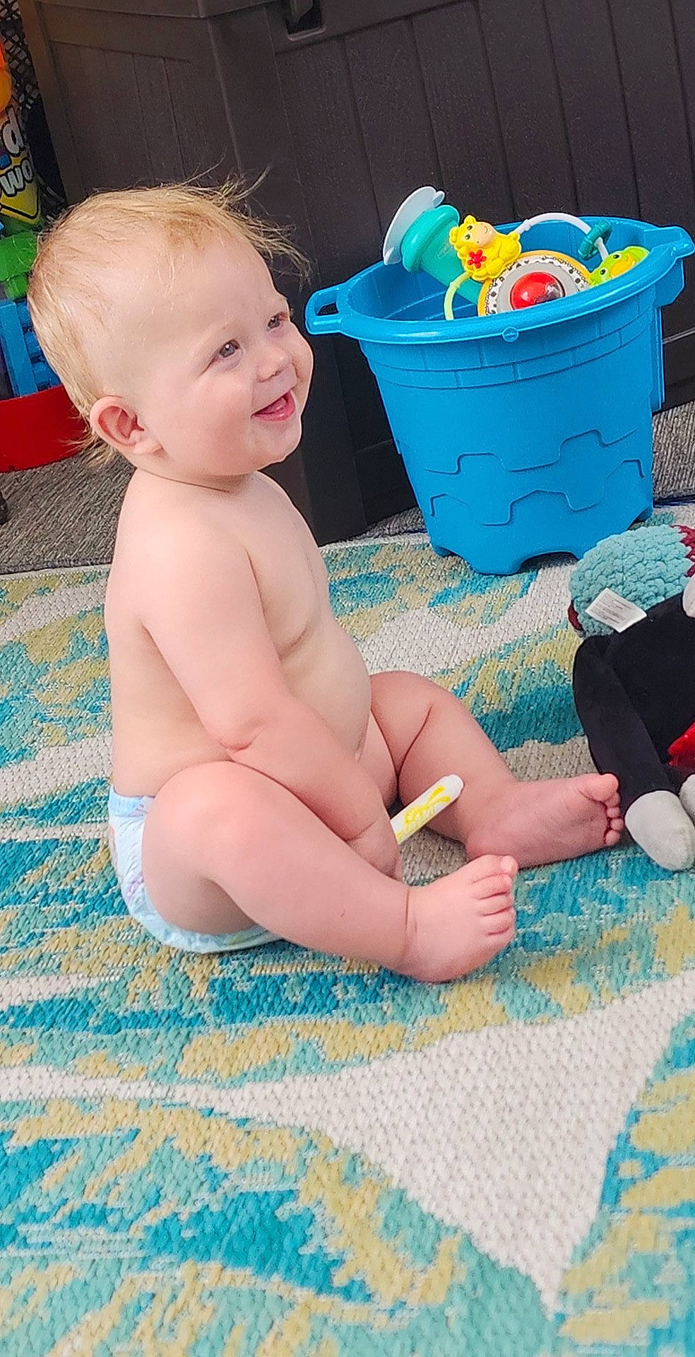 Kobe is registered to the contest to win money with this photo: aqua, baby, baby_toddler_clothing, blue, chest, child, foot, fun, green, happy, human_leg, leg, leisure, person, play, sitting, smile, thigh, toddler, toy