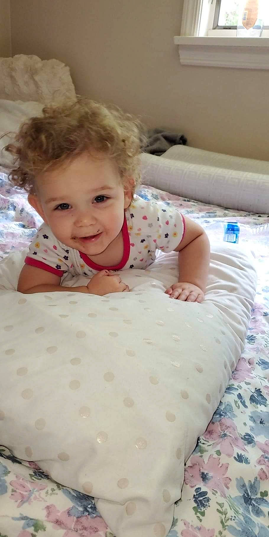 Melissa is registered to the contest to win money with this photo: baby, baby_toddler_clothing, bed, bedding, bedroom, blond, child, comfort, couch, floor, flooring, hair, hairstyle, happy, joy, linens, pattern, person, product, skin