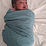 Bryan is registered to the contest to win money with this photo: newborn, baby, swaddled, blanket, infant, sleeping, cozy, cute, child, portrait, lying_down, soft, patterned_sheet, peaceful, wrapped, small_hand, indoor, resting, face, head