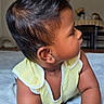 Bryan is registered to the contest to win money with this photo: baby, child, infant, mohawk, hair, curious, lying_down, yellow_clothing, arm, hand, face, skin, indoors, bedspread, furniture, table, flower_vase, soft_light, portrait, cute