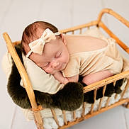 Kinley joined the competition — help win amazing prizes! baby, sleeping, wicker_bed, bow_headband, blanket, cozy, infant, soft_lighting, cream_outfit, resting, cute, newborn, peaceful, portrait, indoor, child, sleep, toddler, headband, furniture