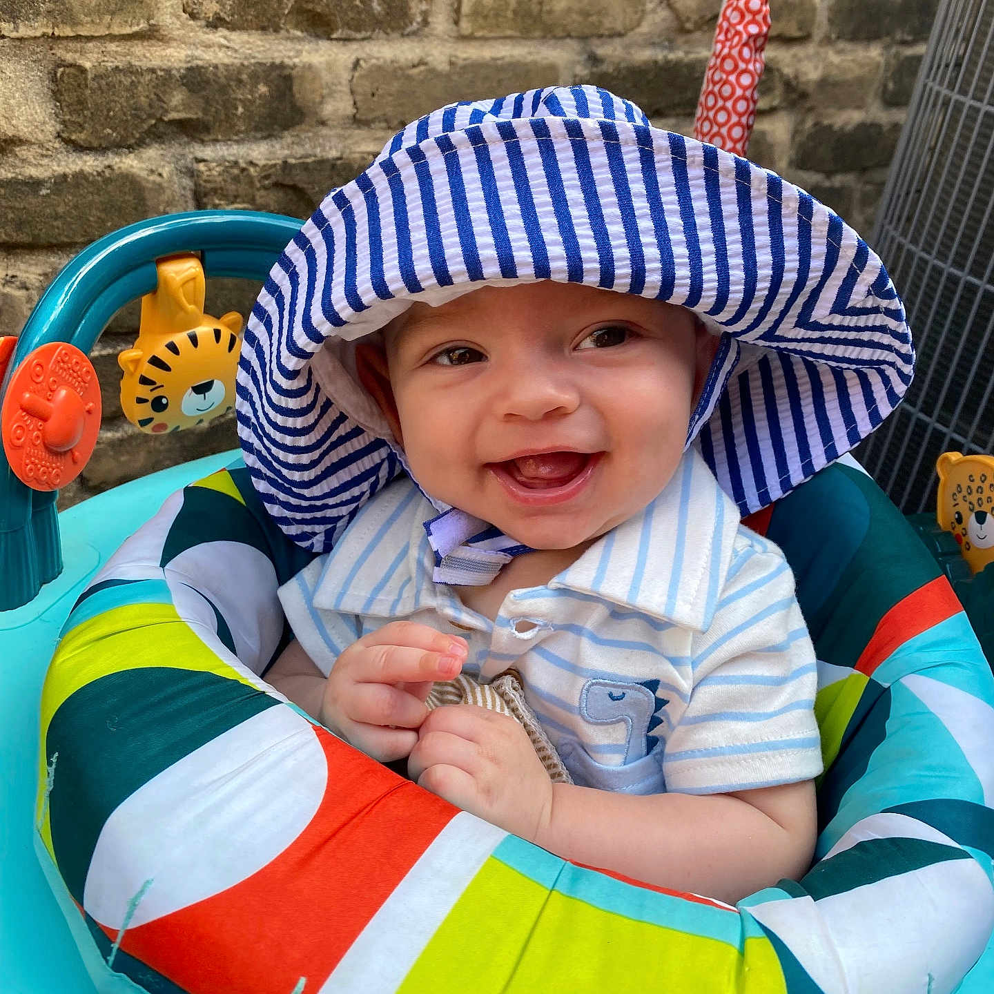 Matt is registered to the contest to win money with this photo: baby, bonnet, cap, clothing, coat, cutlery, face, furniture, happy, hat, head, person, photography, portrait, sitting, smile, spoon, summer, sunhat, water