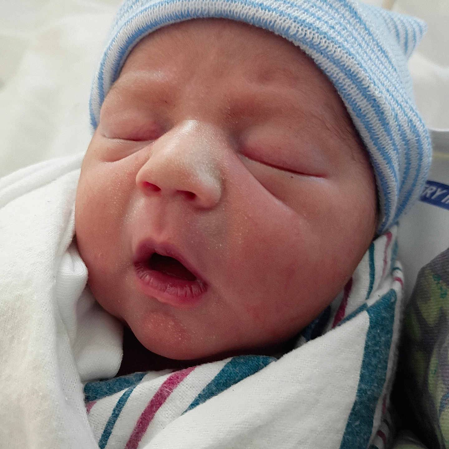 Declan joined the competition — help win amazing prizes! baby, beanie, blanket, child, closeup, cute, face, fresh, hospital, infant, mouth_open, newborn, peaceful, person, sleeping, small, soft_skin, striped_hat, swaddled, wrapped