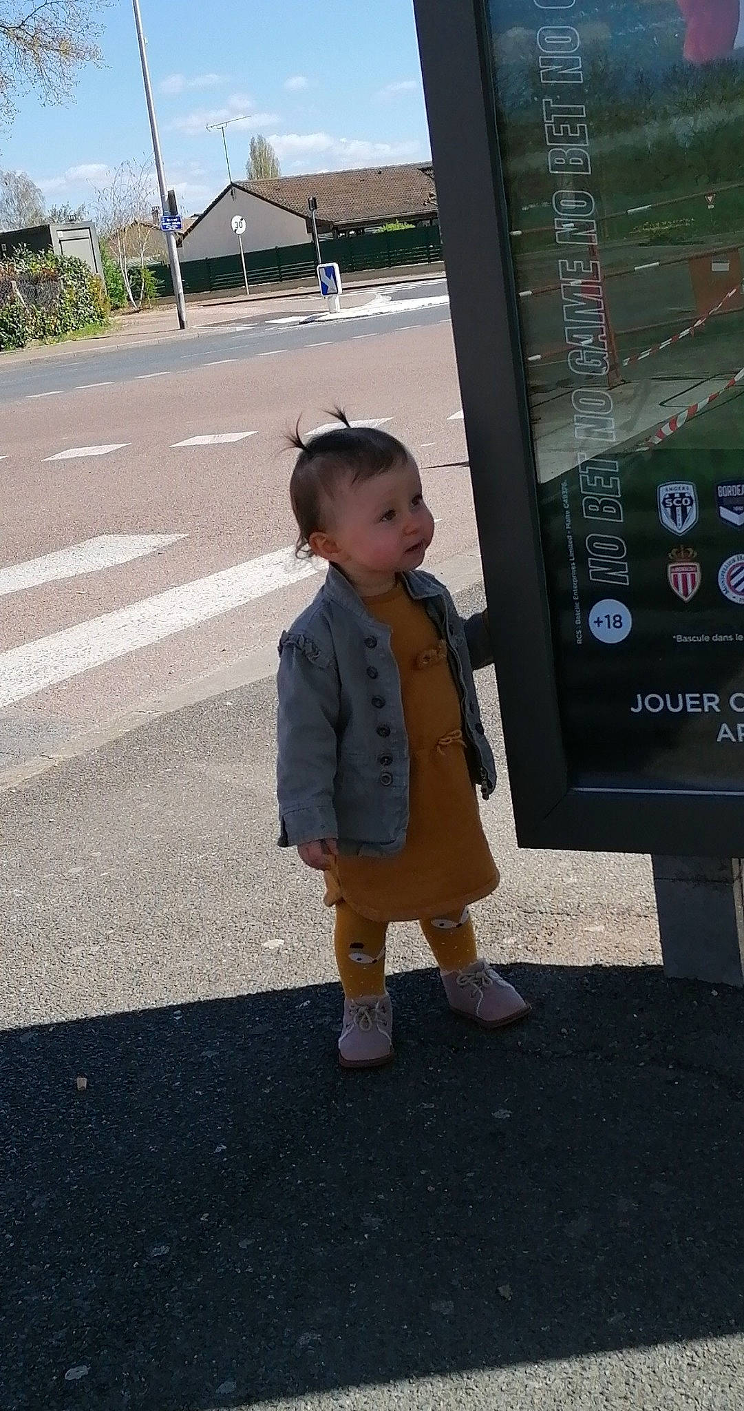 Kalyana participe au concours pour gagner de l'argent avec cette photo : asphalt, child, city, display_device, fun, human_settlement, lane, machine, pedestrian, person, road, road_surface, shadow, sidewalk, sky, standing, street, toddler, transport, tree