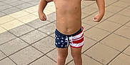 Waylon joined the competition — help win amazing prizes! barefoot, boy, child, confidence, fun, hair, muscle_pose, outdoor, patriotic, playful, poolside, reflection, shorts, skin, summer, sunglasses, swimwear, tiles, vacation, water