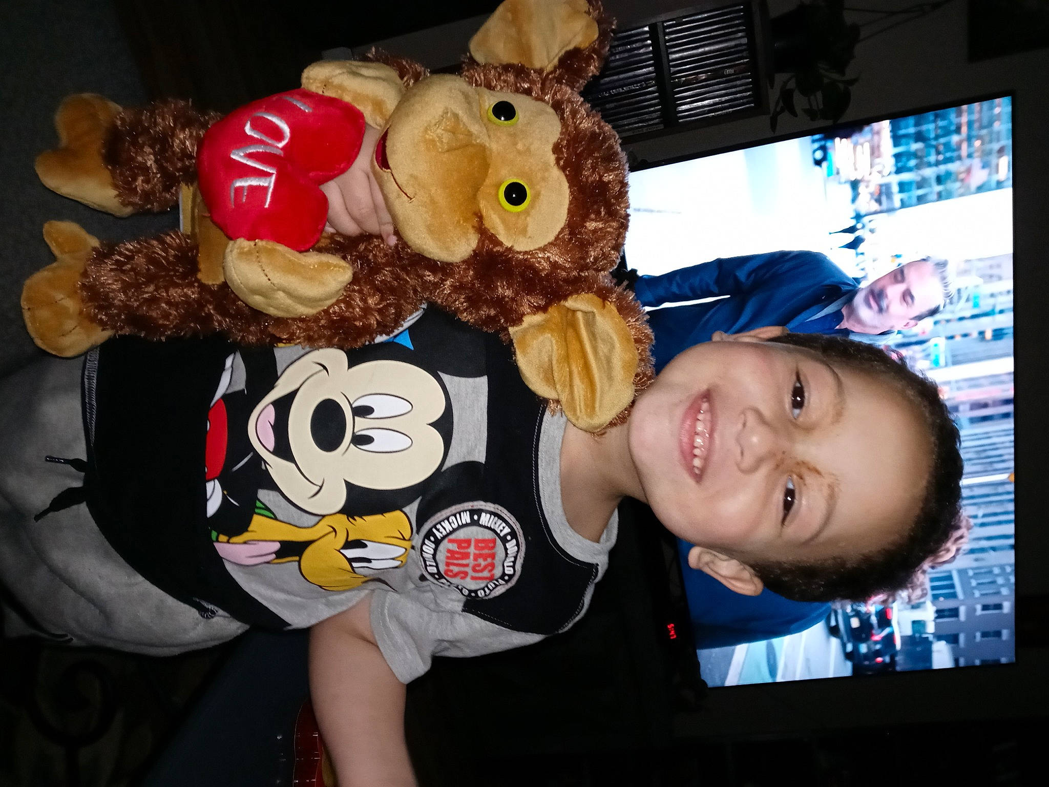 Isaiah joined the competition — help win amazing prizes! baby_toddler_clothing, child, display_device, flash_photography, fun, fur, happy, joy, party, person, plush, room, smile, stuffed_toy, t_shirt, teddy_bear, toddler, toy, world