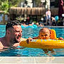 Emma a rejoint le concours — aidez-le/la à gagner de superbes lots ! baby, man, pool, water, inflatable_ring, swimming, sunlight, outdoor, summer, fun, child, floating, recreation, leisure, people, adult, happy, vacation, blue, relaxation