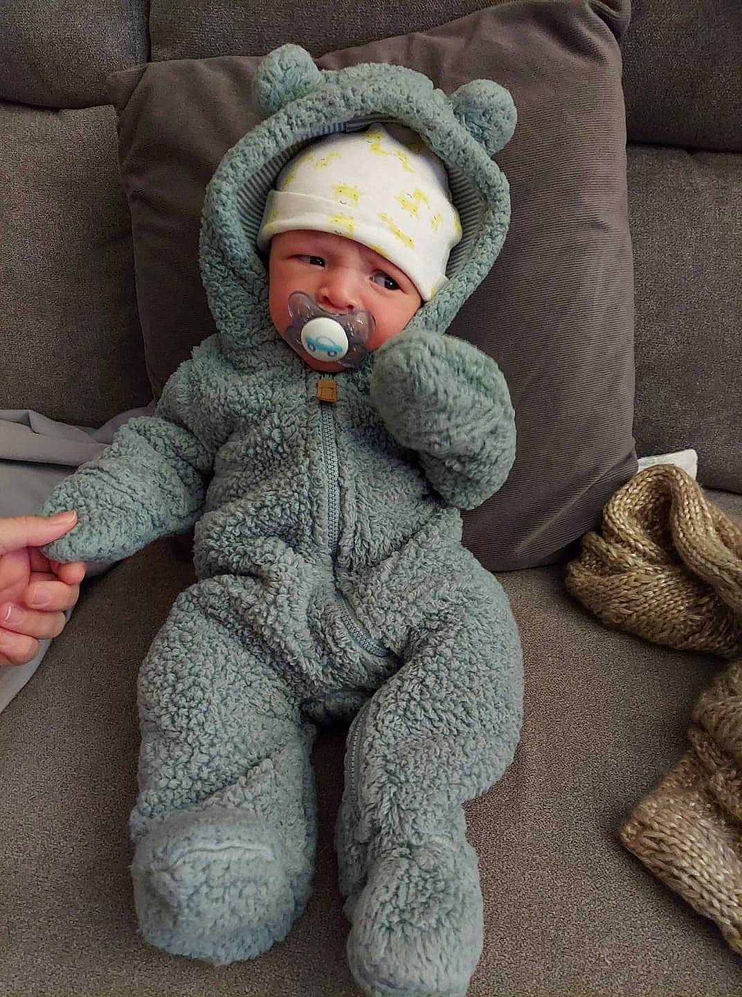 Braden is registered to the contest to win money with this photo: baby, baby_sleeping, baby_toddler_clothing, cap, cheek, child, collar, comfort, finger, fur, grey, headgear, headwear, linens, pattern, person, sitting, sleeve, thumb, toddler