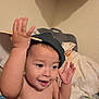 toddler, child, baby, cap, hat, indoor, blanket, smile, happy, cute, gesture, person, skin, face, hand, expression, cozy, bedroom, playful, young