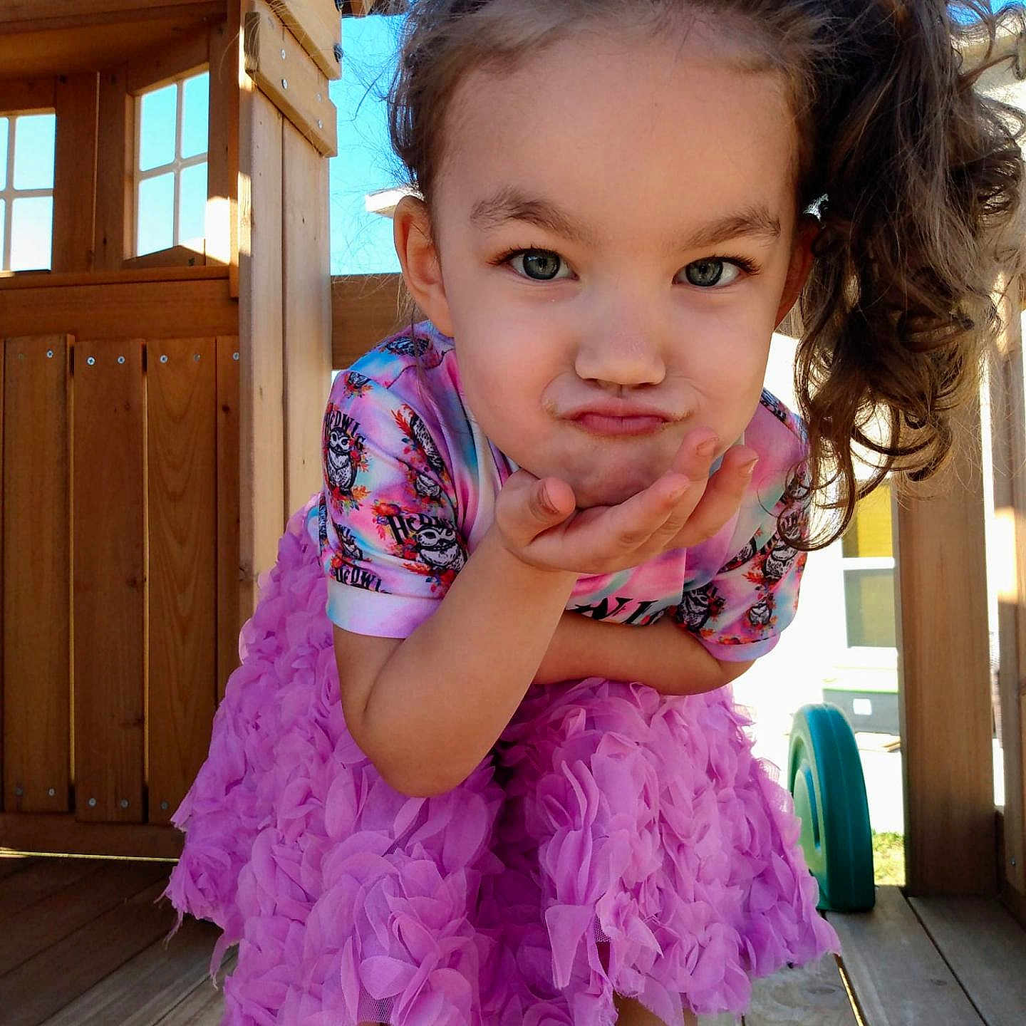 Harley is registered to the contest to win money with this photo: architecture, building, child, clothing, dress, face, female, footwear, head, house, housing, outdoors, person, photography, porch, portrait, purple, shelter, shoe, wood