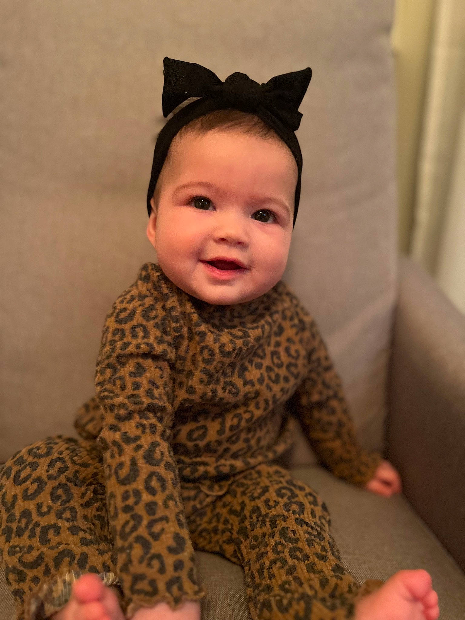 Lillian is registered to the contest to win money with this photo: baby, baby_toddler_clothing, cheek, child, chin, comfort, costume_hat, eye, face, flooring, happy, head, human_leg, joy, pattern, person, sitting, skin, sleeve, smile