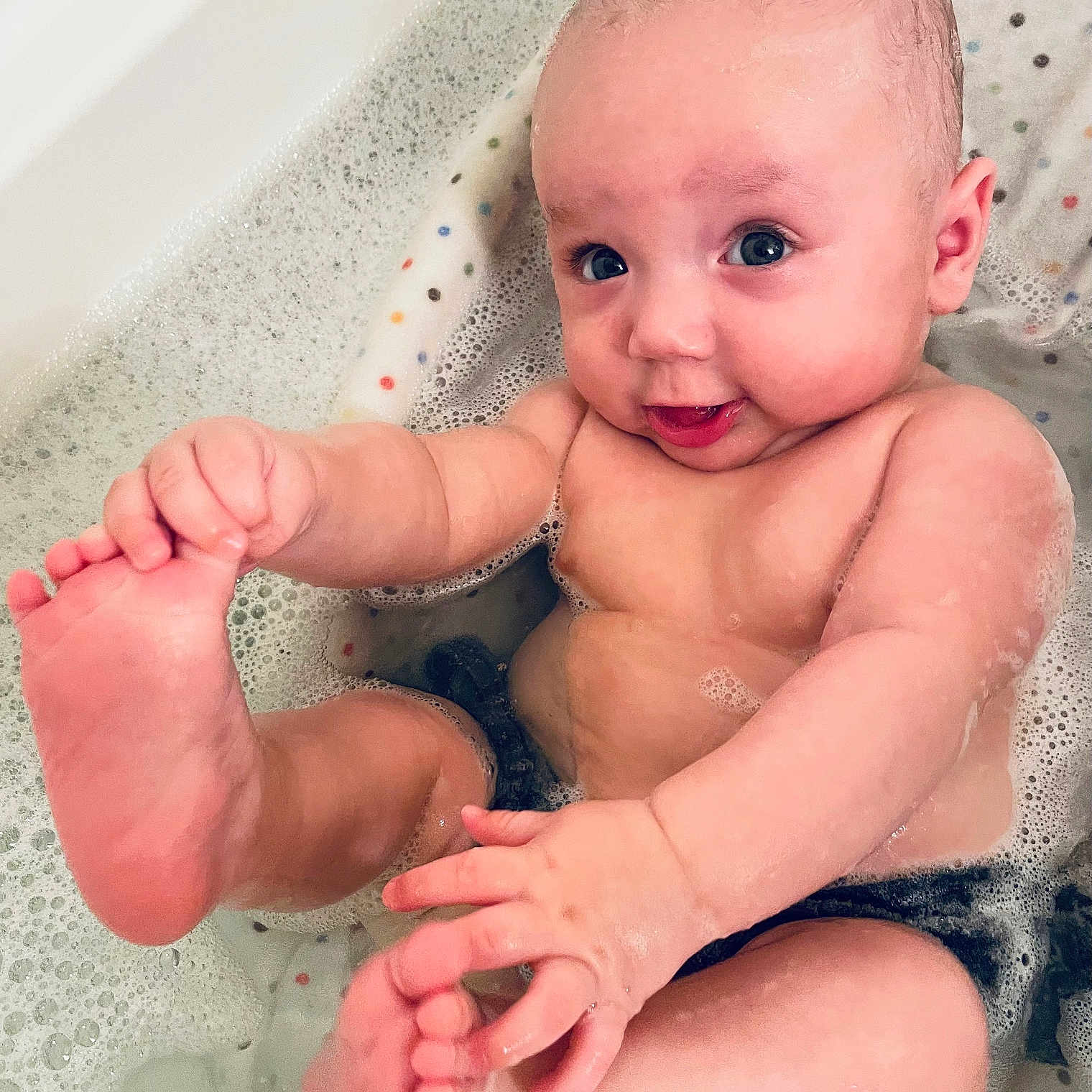 Greyson is registered to the contest to win money with this photo: baby, bathing, bathtub, face, head, person, photography, portrait, sitting, tub