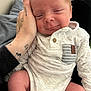 Demetry joined the competition — help win amazing prizes! baby, closeup, clothing, comfort, cute, face, hand, indoor, infant, legs, newborn, onesie, person, pocket, relaxation, sitting, skin, smile, soft_fabric, tattoo