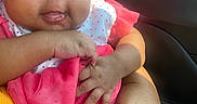Jaliyah Aka Cookie is registered to the contest to win money with this photo: adult_hand, baby, car, caregiver, child, city, close_up, daylight, dress, eyes, face, infant, interior, pink_clothing, polka_dots, portrait, seated, storefront, vehicle, window