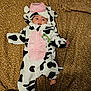 baby, cow_costume, infant, blanket, leopard_print, foot, cute, lying_down, costume, animal_print, indoor, person, child, soft_texture, plush, hooded_outfit, black_and_white, pink, clothing, portrait