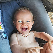 Dixon participe au concours pour gagner de l'argent avec cette photo : arm, baby, baby_clothes, blue_eyes, child, cute, fabric, hand, happy, infant, necklace, outdoor, person, playful, portrait, seat, skin, smiling, stroller, young_child
