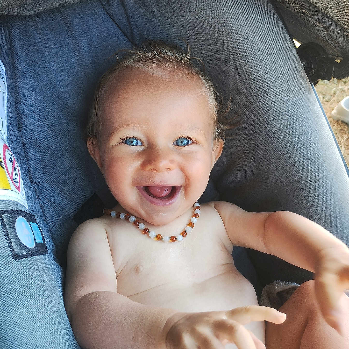 Dixon participe au concours pour gagner de l'argent avec cette photo : arm, baby, baby_clothes, blue_eyes, child, cute, fabric, hand, happy, infant, necklace, outdoor, person, playful, portrait, seat, skin, smiling, stroller, young_child