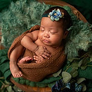 Oona is registered to the contest to win money with this photo: baby, sleeping, newborn, blanket, headband, flower, greenery, leaves, soft_texture, cozy, peaceful, wrapped, infant, portrait, cute, resting, natural, wooden_bowl, decor, photography